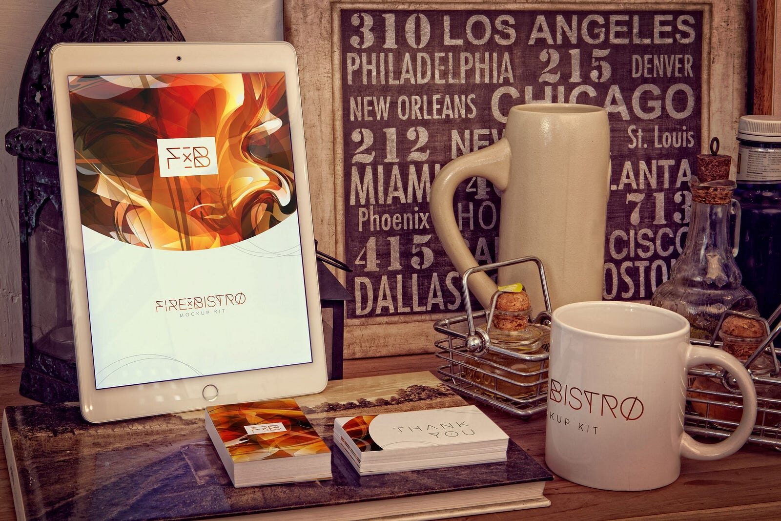 A bistro's brand shown on a tablet, business cards, thank-you cards and a mug